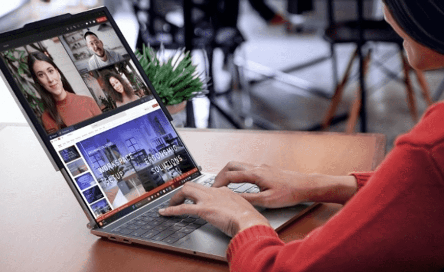 A Women Is Working On A Laptop