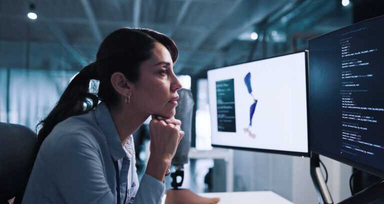 Woman, Thinking And Developer With Design For Prosthetic Leg, Programming Or 3d Printing In Lab. Thoughtful, Female Person Or Biomedical Engineer Contemplating On Computer For Artificial Development