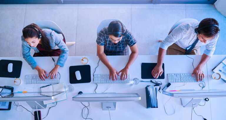 Call Center, Computer And Top View With Business People In Office For Communication, Customer Service And Contact Us. Help Desk, Online And Team Of Employee In Agency For Consulting And Advisory