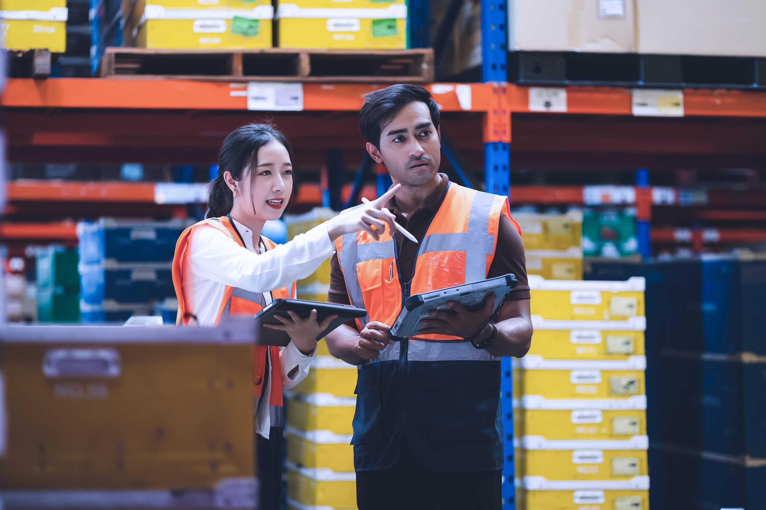 Warehouse Worker And Manager Checks Stock And Inventory With Usi