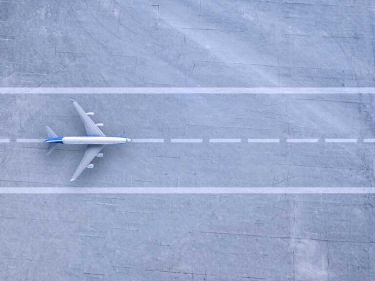 An aeroplane positioned on a runway viewed from above, highlighting aircraft alignment with runway markings.