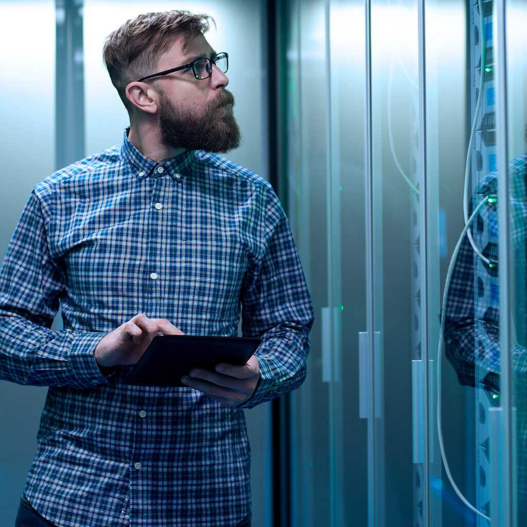It Engineer With Tablet In Server Room
