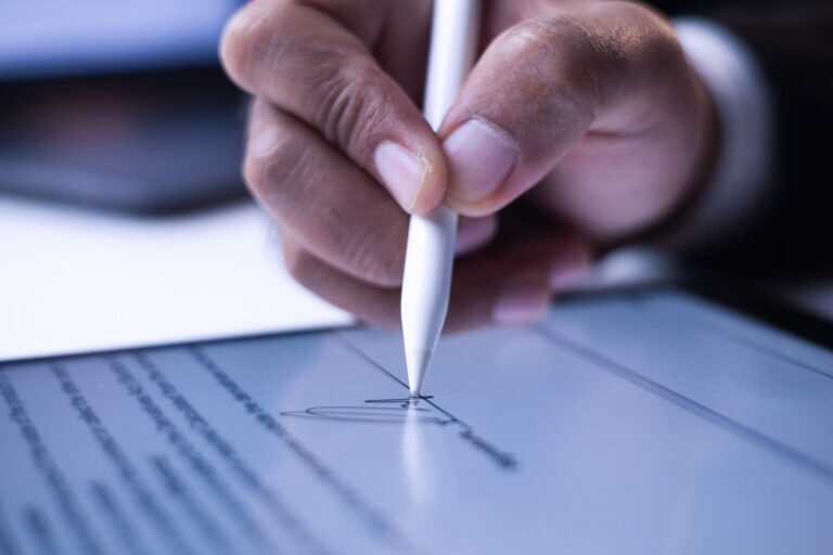 Close Up Businessman Hand Electronic Signature On Tablet By Styl
