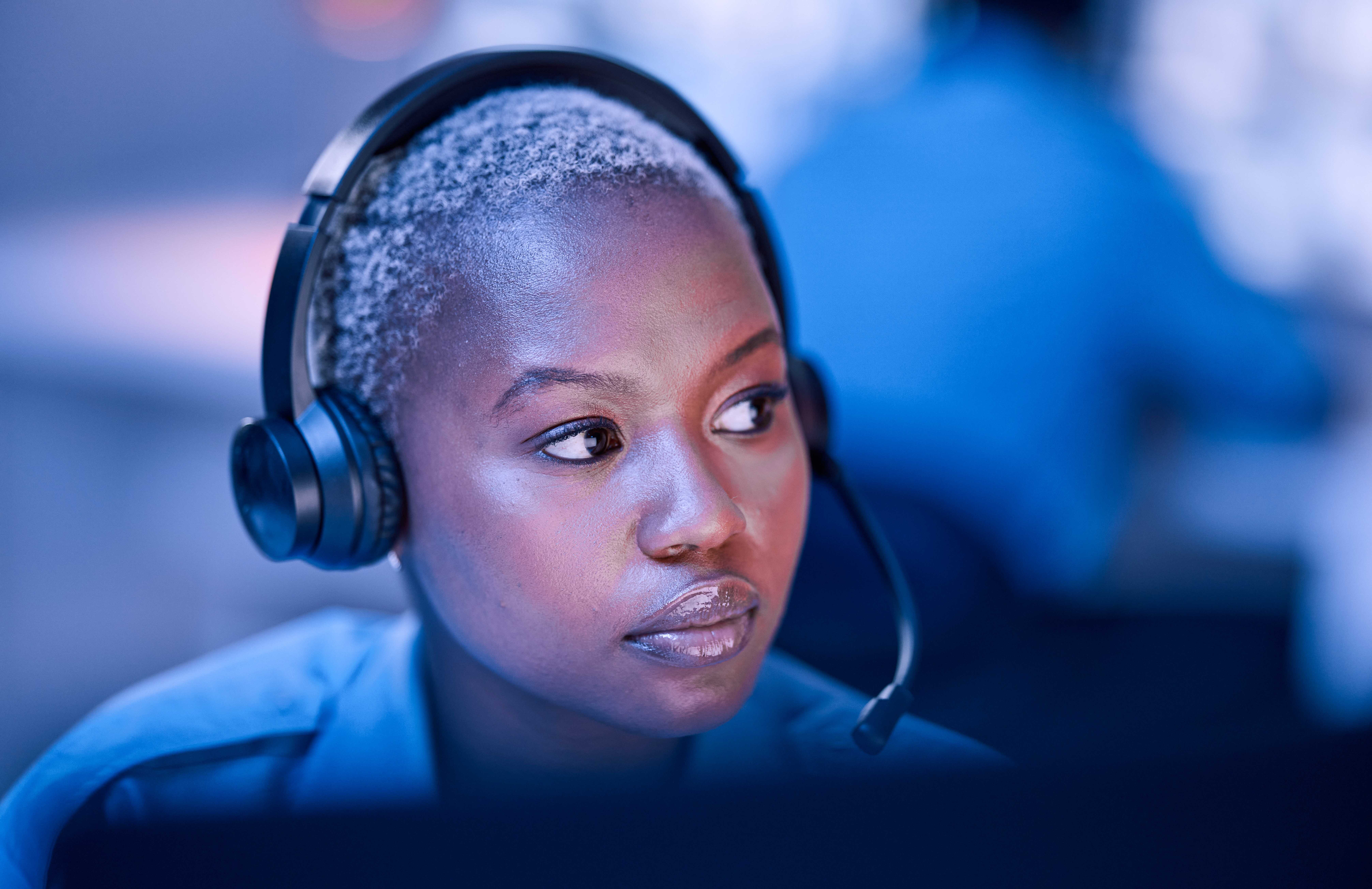 Photograph showing a person wearing a headset with a microphone.