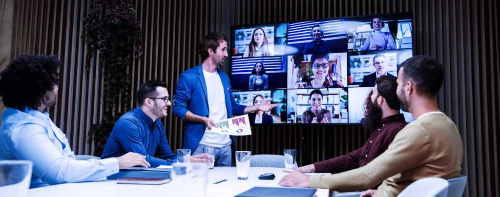 Group Of Businessmen Having A Video Conference Meeting With Their Coworkers