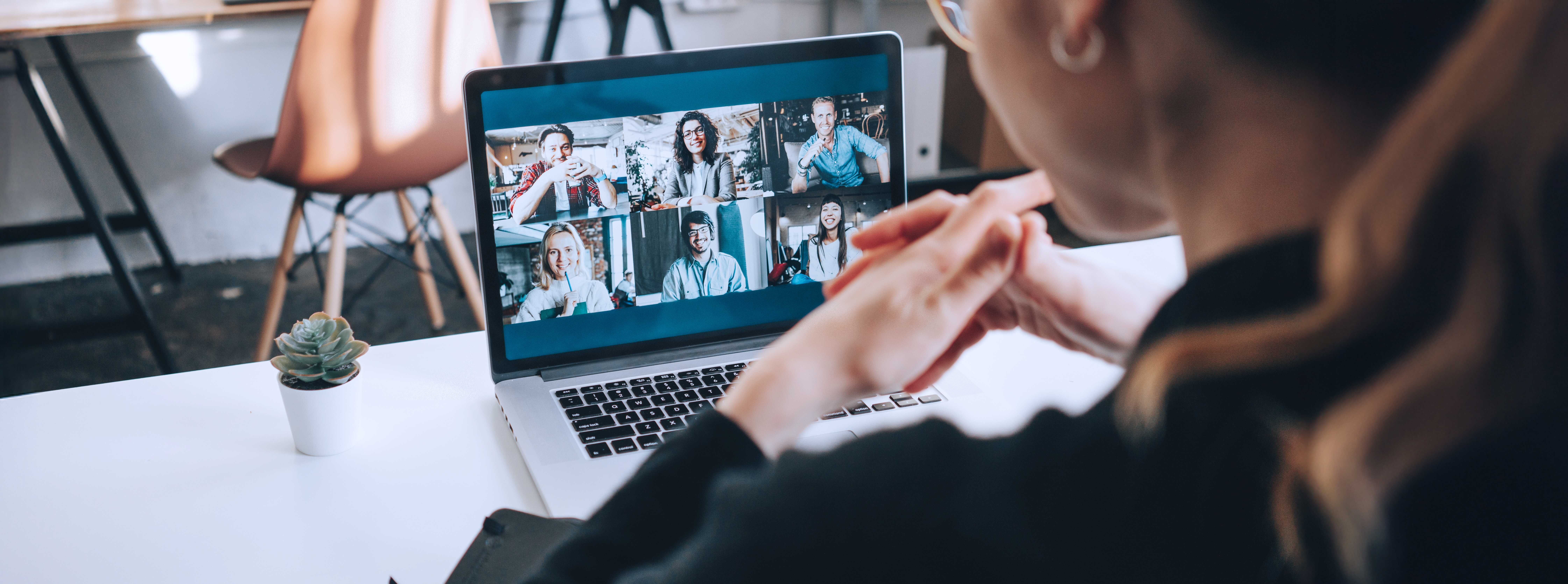 Woman Has Video Conference With Her Remote Team Using Laptop And