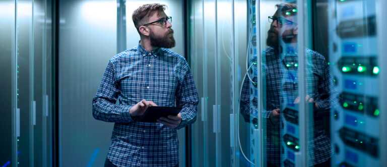 It Engineer With Tablet In Server Room