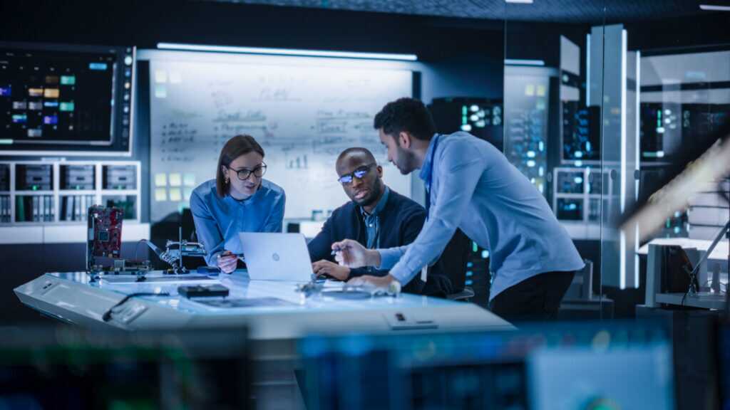 Diverse Team Of Engineers Collaborating On Manufacturing Project